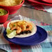 A Tuxton Concentrix cobalt blue plate with shrimp and cheese tacos.