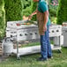 A man cooking food on a Backyard Pro stainless steel outdoor griddle.