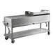 A large stainless steel Backyard Pro outdoor grill on wheels.