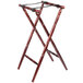 A Lancaster Table & Seating mahogany wooden folding tray stand with turned legs.