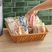 A hand holding a basket of Chef Pierre assorted danishes in plastic bags.
