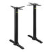 A pair of FLAT Tech black metal table bases stacked on top of each other.