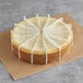 A cheesecake with white strips on top.
