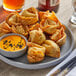 A plate of Amoy Royal Dragon Crab Rangoon with dipping sauce.