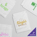A group of white Vela layflat shipping bags with green text.