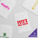 A group of white Vela layflat shipping bags with custom text in various colors.