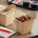 Emperor's Select takeout boxes filled with food on a table.