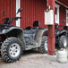 A black ATV parked in front of a red building.