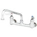 A T&S chrome wall mounted pantry faucet with two handles and a swing nozzle.