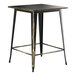 A Lancaster Table & Seating black and gold outdoor bar height table with a distressed top.