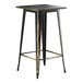 A black metal bar table with a distressed gold top.
