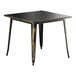 A black and gold Lancaster Table & Seating outdoor table with a black top.