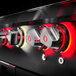 The control knobs of a black and red Crown Verity built-in liquid propane grill.