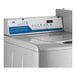 A white Encore commercial top load washer with buttons and dials.
