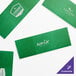 Green customizable paper napkin bands with white text.