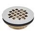 The round metal grid for an Oatey brass shower drain with holes.