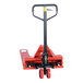 A red pallet jack with black wheels.