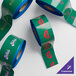 A roll of green Superior Mark safety tape with customizable text.