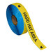 A roll of yellow and black Superior Mark safety tape with the words "Hard Hat Area" in black.