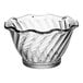 A clear plastic dessert dish with a wavy edge.