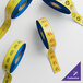 Three rolls of Superior Mark yellow and blue safety tape.