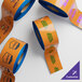 A roll of orange and blue tape with a blue edge and orange labels.