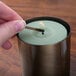 A hand lighting a candle using a D.D. Bean & Sons Co matchbook.