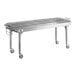 A large stainless steel table with wheels.