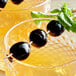 Two glasses of Luxardo Original Maraschino Cherries on a table in a cocktail bar.