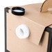A cardboard box of Sabert coffee take out containers with a white and black lid.