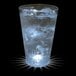 A customizable plastic pint cup filled with ice water and a white LED light shining through it.