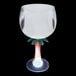 A clear plastic goblet with a palm tree stem and white LED light.