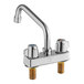 A chrome deck-mount faucet with two handles and an 8" swing spout.