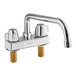 A chrome deck-mount faucet with two silver handles.