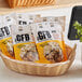 A bag of GFB Peanut Butter Bites on a table with a basket of food.