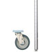 A metal pole with a silver cylinder and a wheel.