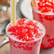 Two plastic cups of pink drinks with Fanale strawberry heart-shaped jelly toppings and straws.