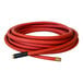 A coiled red commercial hot water hose with brass fittings.