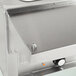 A stainless steel counter top with a metal well opening.