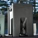 A black plastic Carlisle Cateraide XT insulated beverage dispenser with a spigot.