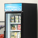 An Avantco blue graphic sign panel on a refrigerator with ice cream and ice cream in it.