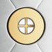 A circular stainless steel drainboard with a cross in the middle.