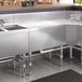 A Regency stainless steel underbar drainboard on a counter.