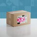 A cardboard box of Adourne Pink Sprinkles with a pink and white label.