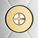 A circular gold object with a cross in the center.
