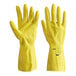 A pair of large yellow latex rubber gloves with a raised texture on the hand.
