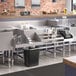 A Regency stainless steel combination cocktail station with a drainboard on a counter.