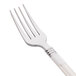 A close-up of a WNA Reflections Duet stainless steel look fork with an ivory handle.