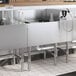 A Regency stainless steel underbar ice bin with a cold plate and bottle holders on a counter.
