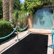 A black FloorEXP carpet runner with blue rope around it.